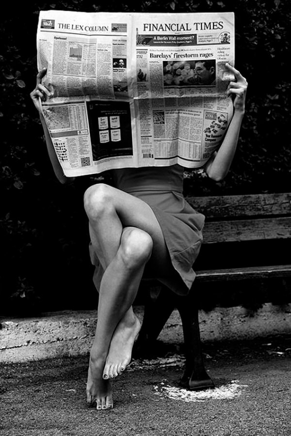 Woman reading financial times newspaper