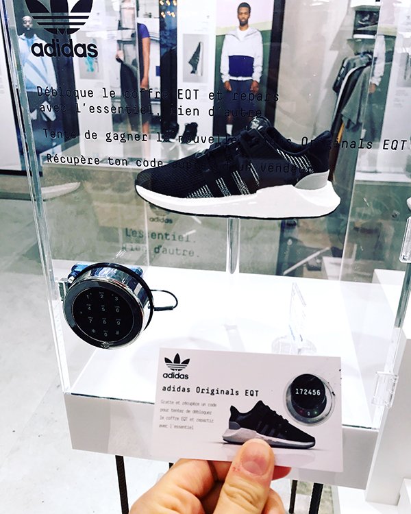 Scratch card to win Adidas Trainers concealed inside a glass box