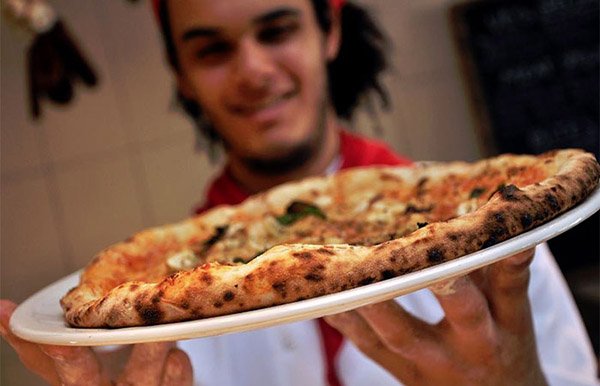 Man holding Franco Manca Pizza