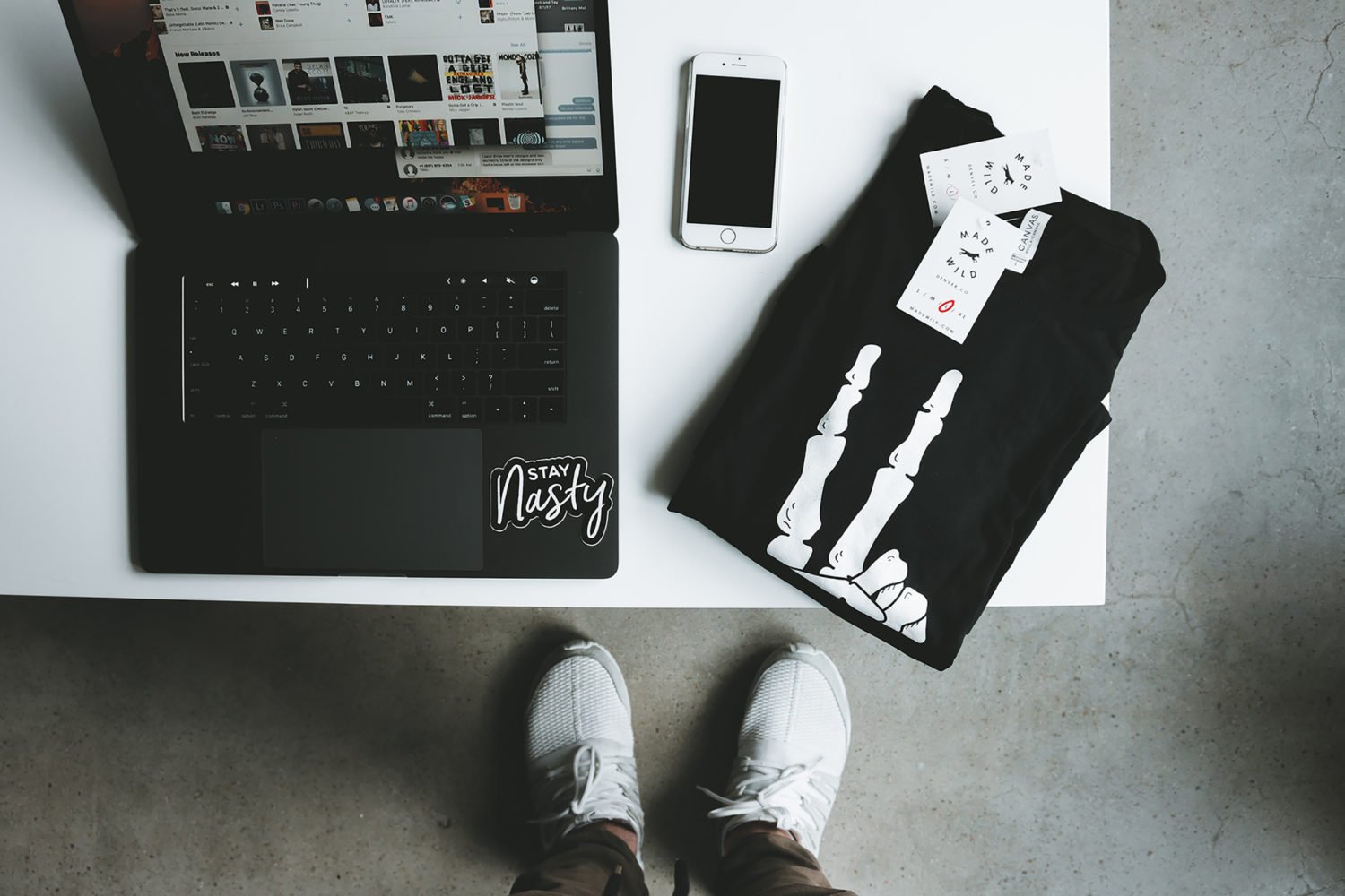 Macbook with iPhone and T-shirt