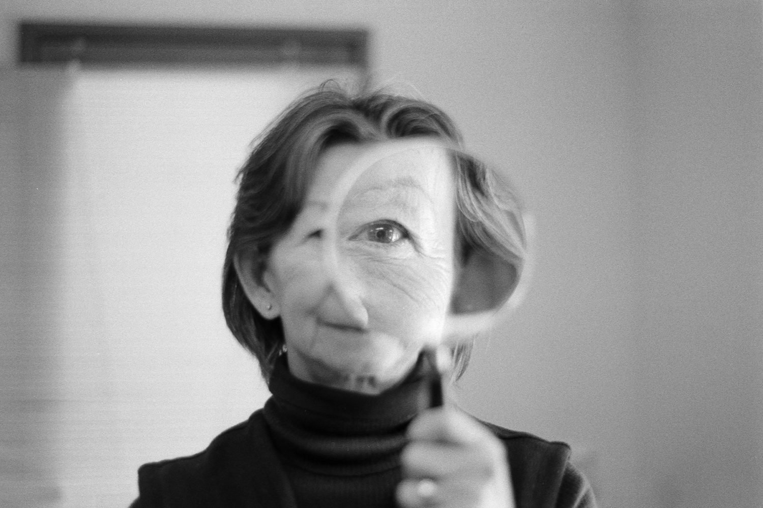 woman looking into magnifying glass
